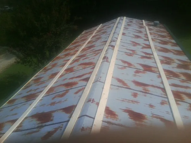 Rusted metal roof panels with new wood purlins before replacement — Storm Damage Roof Repair in Represa by Roofing Brothers